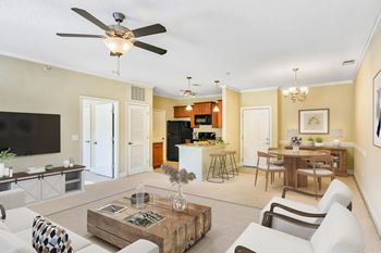 A living room with a white ceiling fan and a black television.